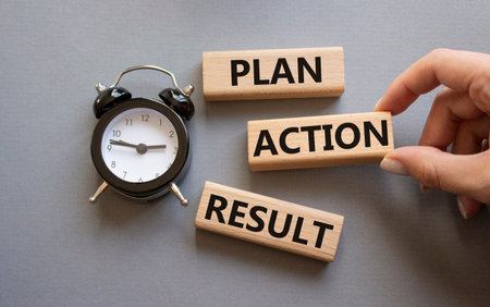 Plan Action Result symbol. Concept words Plan Action Result on wooden blocks. Businessman hand. Beautiful gray background with alarm clock. Business concept and Plan Action Result. Copy space.の写真素材