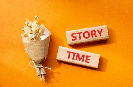 Story Time symbol. Wooden blocks with words Story Time. Beautiful orange background. Business and Story Time concept. Copy space.の写真素材