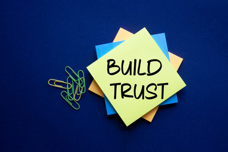 Build trust symbol. Build trust on sticky note. Beautiful deep blue background. Business and Build...