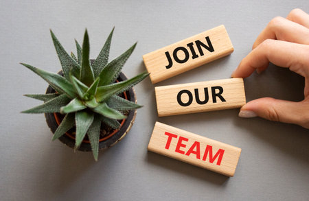 Join our team symbol. Wooden blocks with words Join our team. Beautiful gray background with succulent plant. Businessman hand. Business and Join our team concept. Copy space.の写真素材