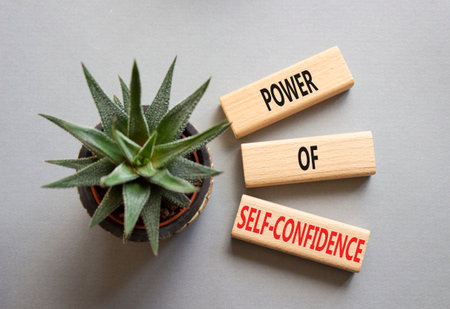 Self-Confidence symbol. Wooden blocks with words Power of Self-Confidence. Beautiful gray background with succulent plant. Business concept. Copy space.の写真素材