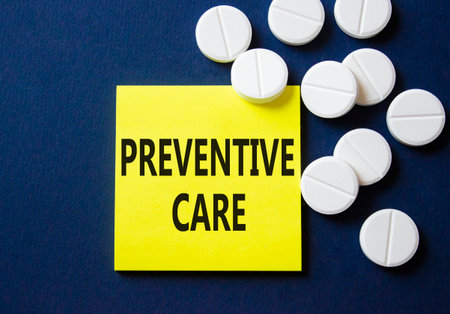 Preventive Care symbol. Concept word Preventive Care on yellow note. Beautiful deep blue background with pills. Medicine and Preventive Care concept. Copy spaceの写真素材