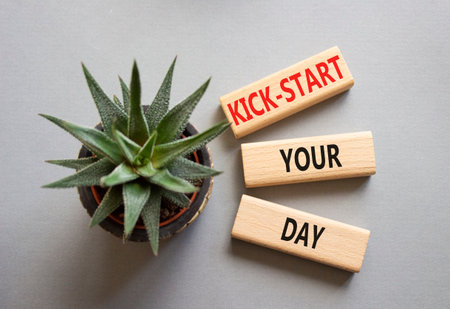 Wooden blocks with words Kick-start your day. Beautiful gray background with succulent plant. Business and Kick-start your day concept. Copy space.の写真素材
