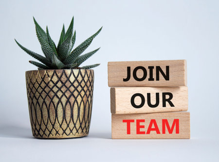 Join our team symbol. Wooden blocks with words Join our team. Beautiful white background with...