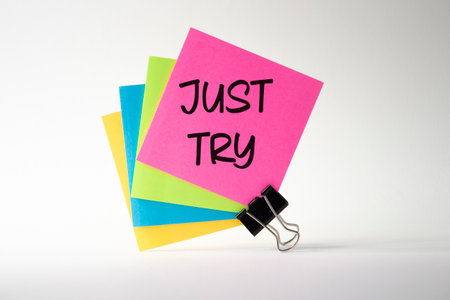 Just try symbol. Pink sticky note with words Just try. Beautiful white background. Business and Just Try concept. Copy space.の写真素材