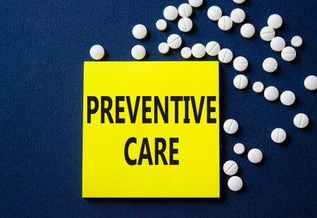Preventive Care symbol. Concept word Preventive Care on yellow note. Beautiful deep blue background...