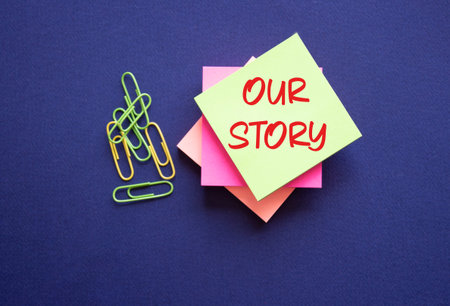 Our story symbol. Yellow sticky note with words Our Story. Beautiful deep blue background. Business...