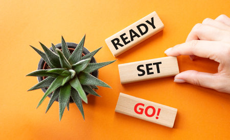 Ready Set Go symbol. Concept words Ready Set Go on wooden blocks. Beautiful orange background with...