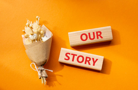 Our story symbol. Wooden blocks with words Our story. Beautiful orange background. Business and Our story concept. Copy space.の写真素材