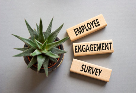 Employee Engagement Survey symbol. Concept words Employee Engagement Survey on wooden blocks. Businessman hand. Beautiful gray background with succulent. Business concept. Copy space.の写真素材