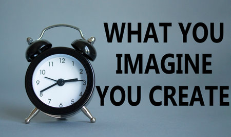 What do you Imagine you Create you symbol. Wooden blocks with words What you Imagine you Create. Beautiful gray background with alarm clock. What do you Imagine you Create concept. Copy space.の写真素材