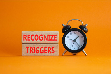 Recognize triggers symbol. Concept words Recognize triggers on wooden blocks. Beautiful orange...