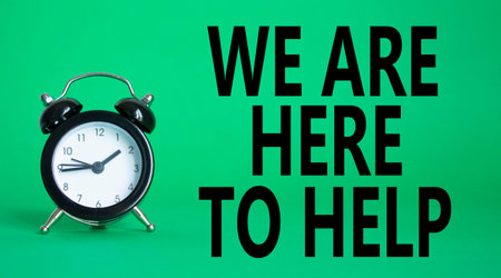 We are here to help symbol. Concept words we are here to help on wooden blocks. Beautiful green...