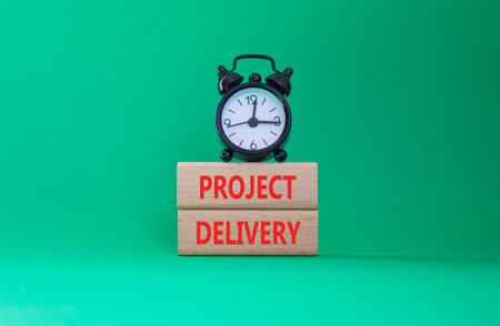 Project Delivery symbol. Concept word Project Delivery on wooden blocks. Beautiful green background...