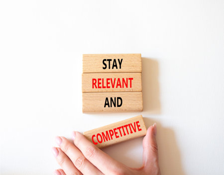 Relevant and Competitive symbol. Concept words Stay Relevant and Competitive on wooden blocks....