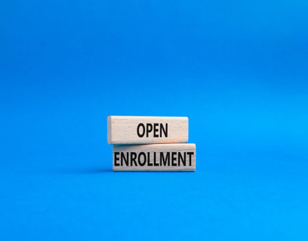 Open Enrollment symbol. Wooden blocks with words Open Enrollment. Beautiful blue background....