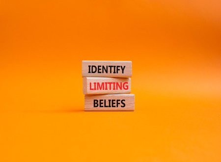 Limiting Beliefs symbol. Concept word Identify Limiting Beliefs on wooden blocks. Beautiful orange...