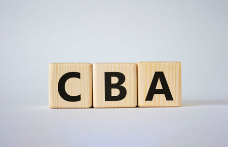 CBA - Cost Benefit Analysis symbol. Wooden cubes with word CBA. Beautiful white background. Business...