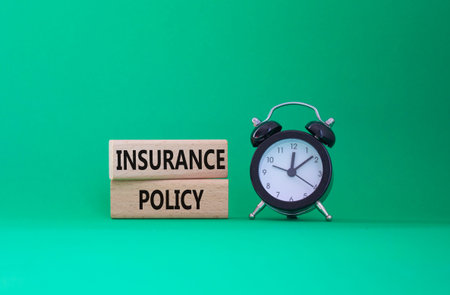Insurance Policy symbol. Concept word Insurance Policy on wooden blocks. Beautiful green background....