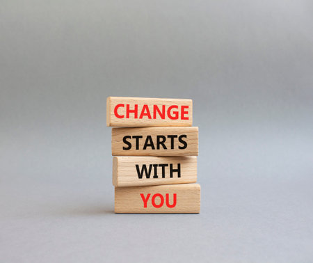 Change symbol. Wooden blocks with words Change Starts With You. Beautiful gray background. Business...
