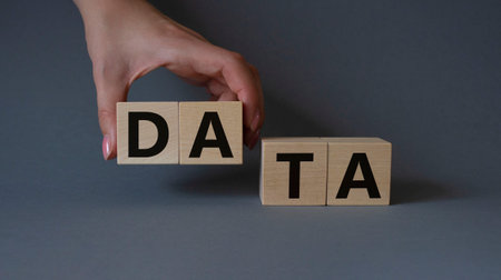 Data symbol. Concept word Data on wooden cubes. Businessman hand. Beautiful gray background. Business and Data concept. Copy space.の写真素材