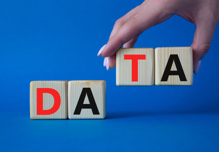 Data symbol. Concept word Data on wooden cubes. Businessman hand. Beautiful blue background. Business and Data concept. Copy space.の写真素材