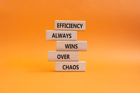 Efficiency symbol. Wooden blocks with words Efficiency Always Wins Over Chaos. Beautiful orange...