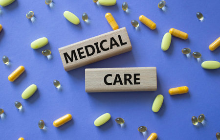 MEDICAL CARE symbol. Concept word MEDICAL CARE on wooden blocks. Beautiful purple background with...