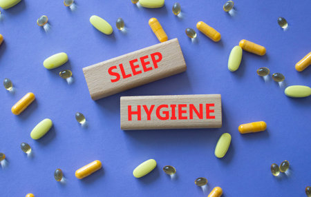 SLEEP HYGIENE symbol. Concept word SLEEP HYGIENE on wooden blocks. Beautiful purple background with pills. Medicine and SLEEP HYGIENE. Copy spaceの写真素材