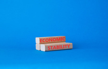 Economic stability symbol. Concept word Economic stability on wooden blocks. Beautiful blue...