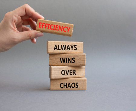 Efficiency symbol. Wooden blocks with words Efficiency Always Wins Over Chaos. Beautiful gray...