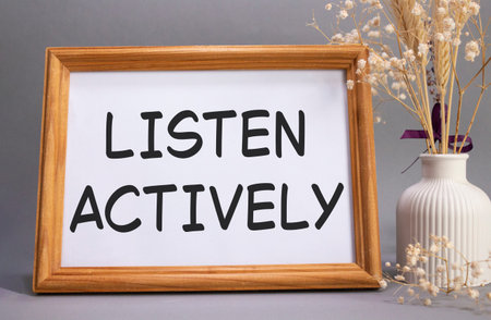 Listen actively symbol. Concept words Listen actively on beautiful wooden picture frame. Beautiful...