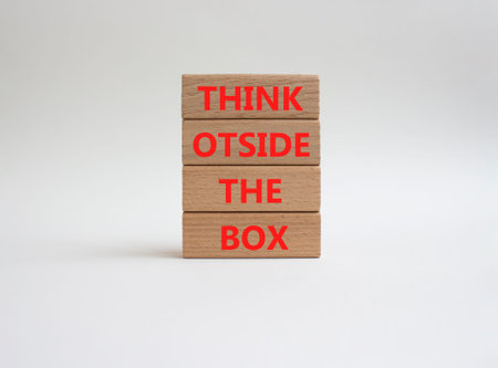 THINK OUTSIDE THE BOX symbol. Wooden blocks with words THINK OUTSIDE THE BOX. Beautiful white background. Business and THINK OUTSIDE THE BOX concept. Copy spaceの写真素材