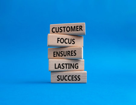Customer Focus symbol. Wooden blocks with words Customer Focus Ensures Lasting Success. Beautiful...