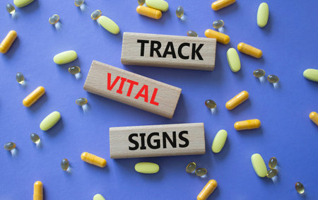 TRACK VITAL SIGNS symbol. Concept words TRACK VITAL SIGNS on wooden blocks. Beautiful purple...