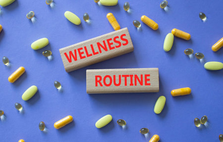 Wellness routine symbol. Concept word Wellness routine on wooden blocks. Beautiful purple background with pills. Medicine and Wellness routine. Copy space