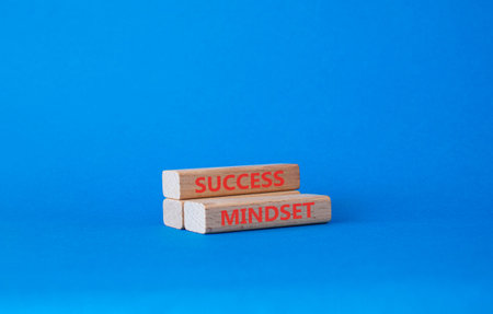 Success mindset symbol. Concept word Success mindset on wooden blocks. Businessman hand. Beautiful blue background. Business and Success mindset concept. Copy space