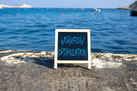 Workflow Optimization symbol. White blackboard with Concept words Workflow Optimization. Beautiful sea background. Business and Workflow Optimization concept. Copy space.