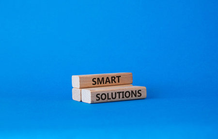 Smart solutions symbol. Concept word Smart solutions on wooden blocks. Beautiful blue background. Business and Smart solutions concept. Copy space