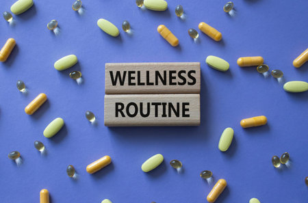 Wellness routine symbol. Concept word Wellness routine on wooden blocks. Beautiful purple background with pills. Medicine and Wellness routine. Copy space