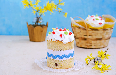 Traditional Easter cake decorated with sugar fondant and multi-colored candied fruits on a light...