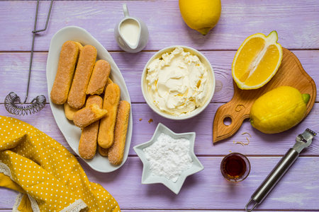 Prepared ingredients for cooking dessert without baking, lemon tiramisu on purple wooden background. Dessert recipes. Valentine's Day. Italian food.の写真素材