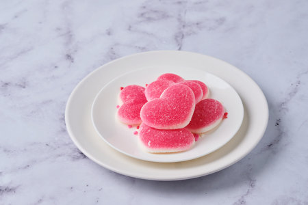 Heart-shaped marmalade on a white plate on a marble background. Valentine's Day concept. Postcard, congratulations for lovers.の写真素材