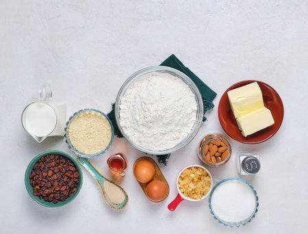 Prepared ingredients for making Christmas baking on white concrete background. Stollen or Christmas cake. Merry Christmas.の写真素材