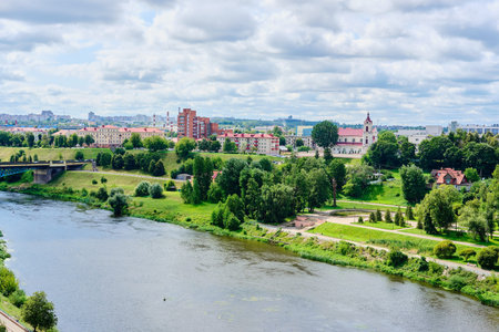 Cityscape, view from the observation deck above the river to the city blocks and green spaces along...
