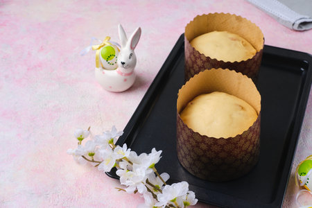 Step by step preparation of Easter cake or other Easter pastries on pink concrete background. Risen...
