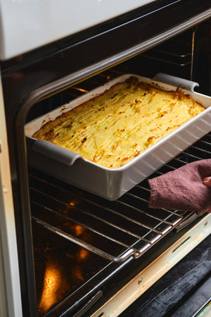 Removing a cooked Potato Casserole or Shepherd's Pie from the Oven. Potatoes Recipes. Thanksgiving day. Comfort Foodの写真素材