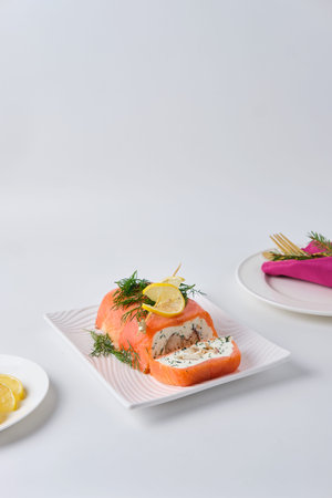A cold appetizer, a terrine of salted salmon and smoked mackerel with cheese cream and dill, served...