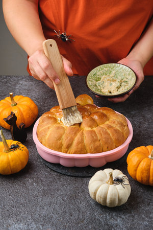 Step by step recipe for pumpkin bread shaped like a Halloween jack-o'-lantern on a dark concrete...