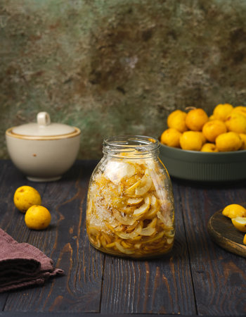 Sliced â€‹â€‹Japanese quince, or Chaenomeles, fruits, seeded and sprinkled with sugar in a...